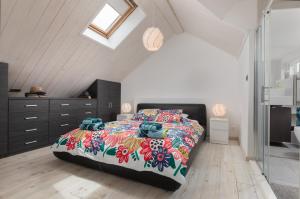 a bedroom with a large bed with a colorful bedspread at Apartment Coastal Villa Makarska in Makarska