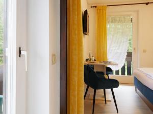 ゼーバハにあるSeebach-Hotelのデスク、ベッド、窓が備わる客室です。