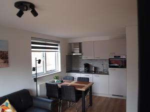 een keuken met een tafel en stoelen in een kamer bij Appartement ,Vakantiewoning, Koddelaan 29 in Zoutelande +4 foto's