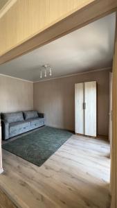 a large room with a bed and a door at Malina guest house in Bosteri