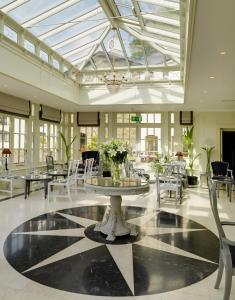 a room with tables and chairs and a glass ceiling at Killarney Heights Hotel in Killarney