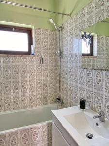 a bathroom with a sink and a window and a tub at Serra Mar in Cruz de João Mendes