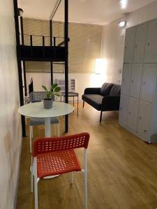 a living room with a table and a loft bed at Burgos Hub Hostel in Manila