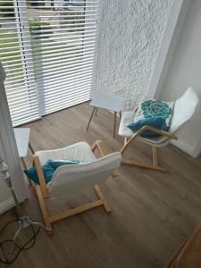 two chairs and a table in a room at Idyllic holiday near Abersoch in Mynytho