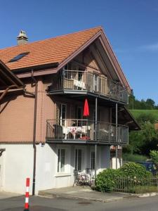 a house with a balcony with a table and chairs at Haus am See - a87679 in Därligen
