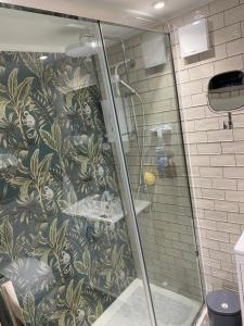 a shower in a bathroom with a mural of monkeys at Cornerstone House in Pickering