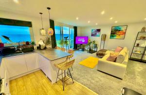 a kitchen and living room with a view of the ocean at Stunning Sea View Two Bed Apartment - With Balcony in Bournemouth