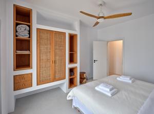 A bed or beds in a room at Siora of Paros - Ammiralis & Castelis