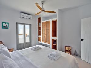 A bed or beds in a room at Siora of Paros - Ammiralis & Castelis