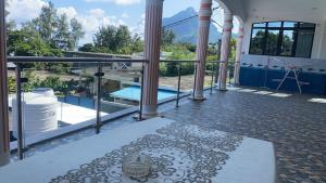 a balcony with a view of a swimming pool at Justice Seaview Apartment in Le Morne