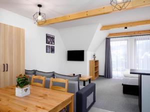 a living room with a dining table and a bedroom at Studio Apartment with Mountain View in Zakopane