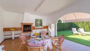 a dining room with a table and chairs and a garden at Casa La Solea Cuevas Bajas by Ruralidays in Cuevas Bajas