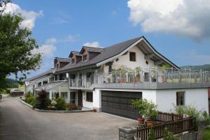 a large white house with a garage at Landurlaub Eichinger in Thurmansbang