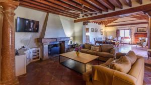 a living room with a couch and a fireplace at Cortijo del Río Antequera by Ruralidays in Antequera