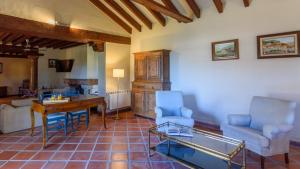 a living room with a table and chairs and a desk at Cortijo del Río Antequera by Ruralidays in Antequera