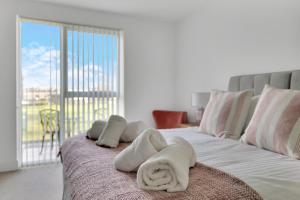 a bedroom with a bed with towels on it at 3 Bed- The Pavilion By Pureserviced in Plymouth