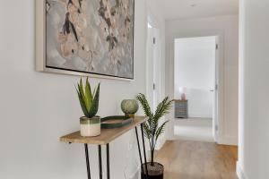 a living room with plants and a painting on the wall at 3 Bed- The Pavilion By Pureserviced in Plymouth