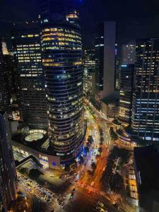 a view of a city at night with traffic at Air Residences Makati - fully furnished condo with skyline views! in Manila