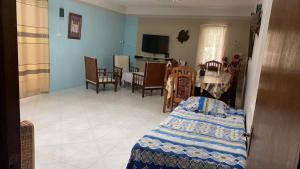 a living room with a bed and a dining room at Justice Seaview Apartment in Le Morne