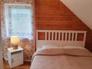 a bedroom with a bed and a window at Forest house Masha in Mrkopalj