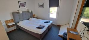 Postel nebo postele na pokoji v ubytování Kramfors Stadshotell AB + 27 fotografií