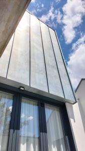 a glass facade of a house with windows at Apartamento Bruño julio y agosto min 7n in Cangas de Morrazo