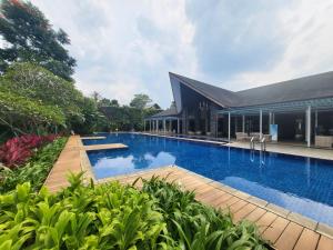 a swimming pool in front of a house at Villa Vimala Hills Semeru in Bogor