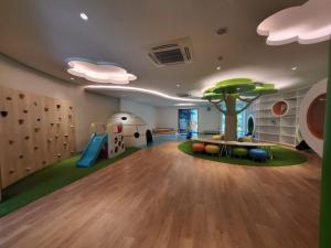 a play room with a tree and a slide at Villa Vimala Hills Semeru in Bogor