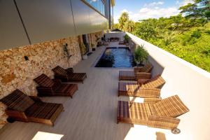 a balcony with chairs and a swimming pool at El Palm in Nadi