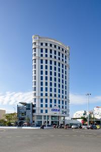 a large white building with a sign on it at Grand Citiview Da Nang Hotel in Da Nang