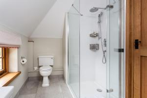 a bathroom with a toilet and a shower at Lower Farm Barn in Hungerford