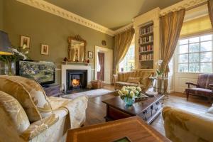 a living room filled with furniture and a fireplace at Eslington East Wing in Alnwick