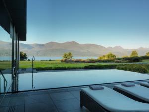 a swimming pool with a view of a lake and mountains at The Europe Hotel & Resort in Killarney