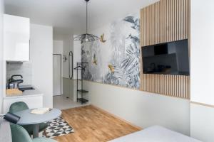 a living room with a table and a kitchen at Pappagallo Apartments in Vienna