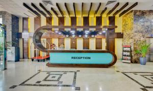 a reception area in a store with a reception sign at Treebo Trend Elysee - Patel Nagar in Dehradun