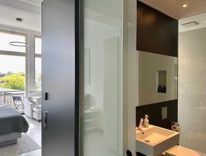 La salle de bains est pourvue d'un lavabo et d'un miroir. dans l'établissement MEOS 1 -Zentrum-Balkon-Parkplatz-Gym, à Leipzig