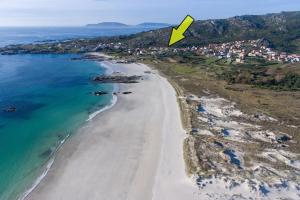 an aerial view of a beach with a yellow arrow at Apartamento Ancora Caldebarcos in San Mamede de Carnota +34 photos