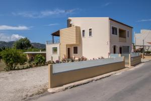 a house with a fence in front of it at Luxury Katsoulakis Apartments in Alikianós