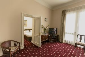 a hotel room with a bed and a mirror at Konstantin Hotel in Samarkand