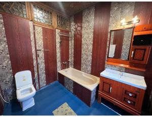 a bathroom with a sink and a toilet and a sink at House Boat Shahnama, Dal Lake in Kārapur