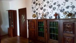 a room with a wooden cabinet with glass doors at DONNA in Tsinsopʼeli