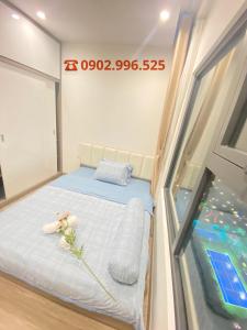 a small bed in a room with a window at Vinhomes Grand Park Quận 9-Bống House in Long Bình