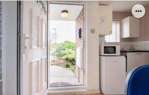 a kitchen with a door leading to a patio at Medway luxury Retreat free parking, Wi-Fi in Chatham