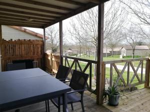 un patio con mesa y sillas en una terraza en Chalet en pleine nature, en La Chapelle-Hermier