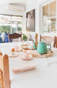 a table with a tea kettle and cups on it at Hope street cottage- Peaceful & private with CBD conveniences in Bathurst