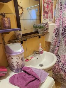 a bathroom with a sink and a pink towel at Apartman Mafini in Krasici