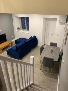a living room with a blue couch and a table at 5 Eyre Square Lane in Galway