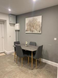 a dining room table with chairs and a painting on the wall at 5 Eyre Square Lane in Galway
