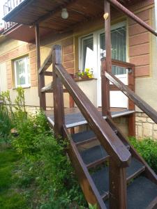 a wooden stairway leading to a porch of a house at Hrnčírna in Kněževes
