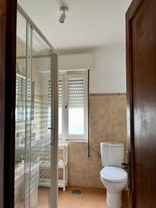 uma casa de banho com um WC e um chuveiro em Villa Rosana em Naveces